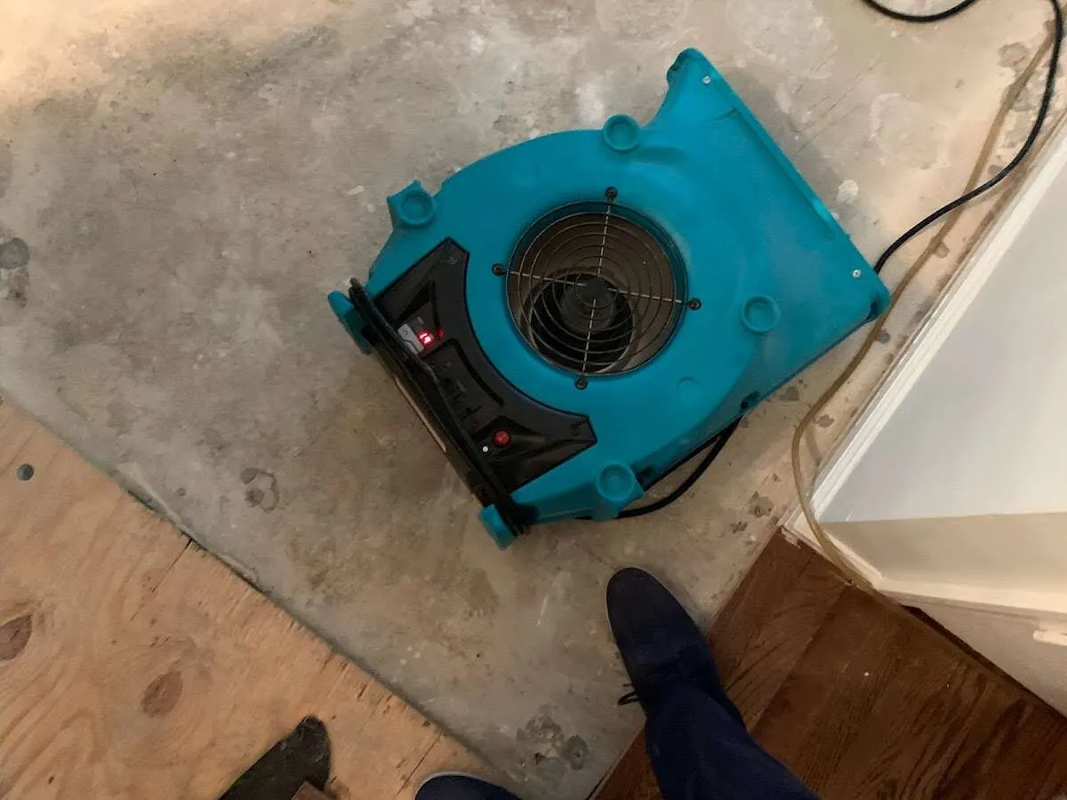 Air mover drying subfloor during Commercial Water Damage Restoration in Offutt AFB
